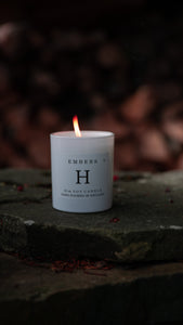 Huskke & Co Embers candle burning on stone, showcasing the benefits of natural candles for a warm, soothing ambiance.